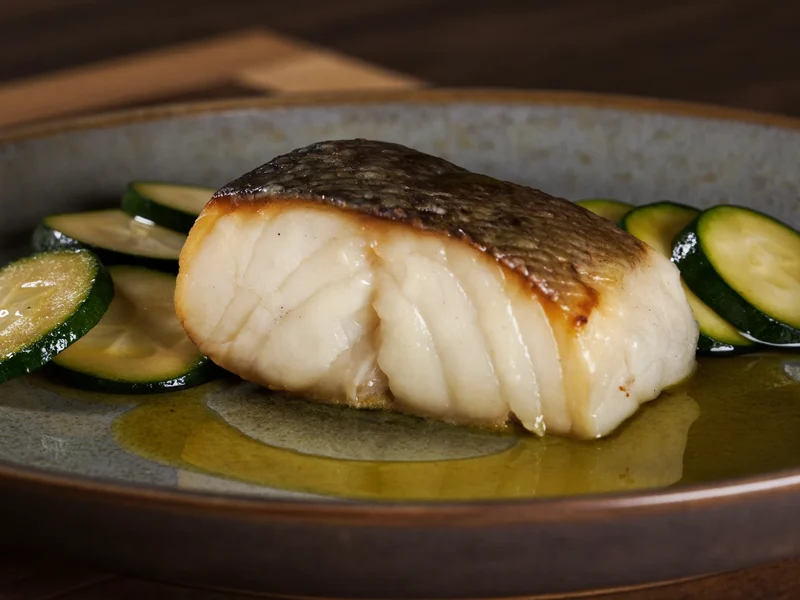 Filetto di pesce bianco al forno con zucchine al vapore e olio d'oliva